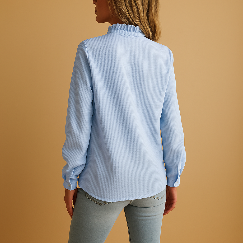 Close-up of a new women's striped long-sleeve blouse with ruffle details and buttons