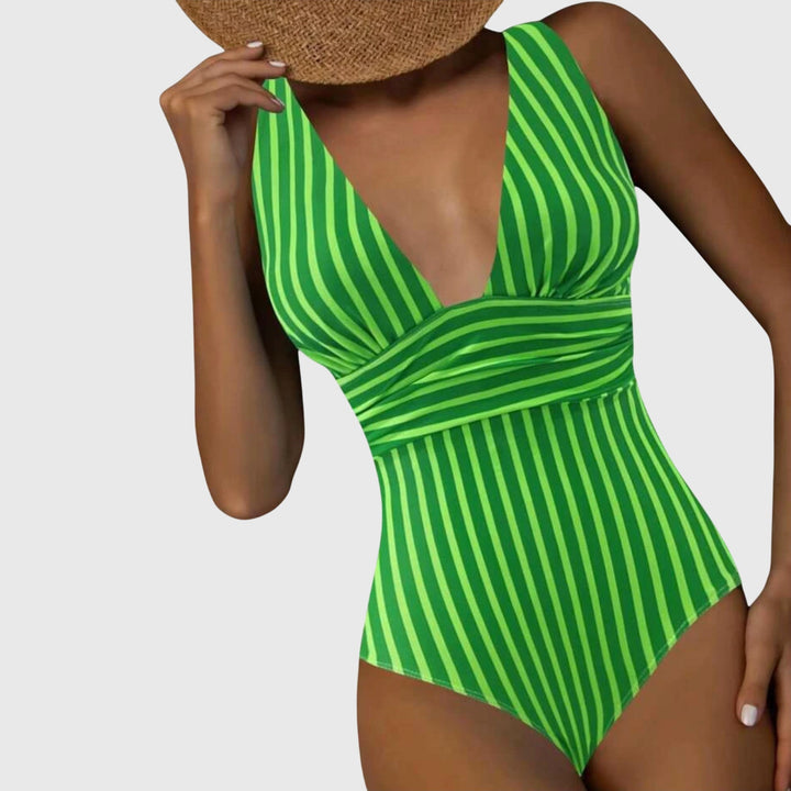 Close-up of the V-neck and striped pattern on a women's one-piece swimsuit, poolside fashion