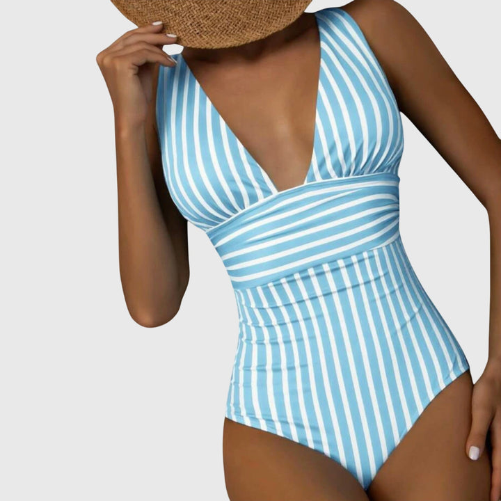 Detail of the fabric and striped design on a women's V-neck one-piece swimsuit, beach ready