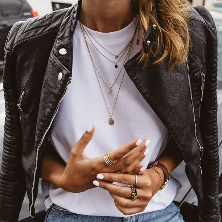 Modern women's outerwear: a fashion-forward quilted biker jacket in black, featuring a sleek asymmetrical zipper.