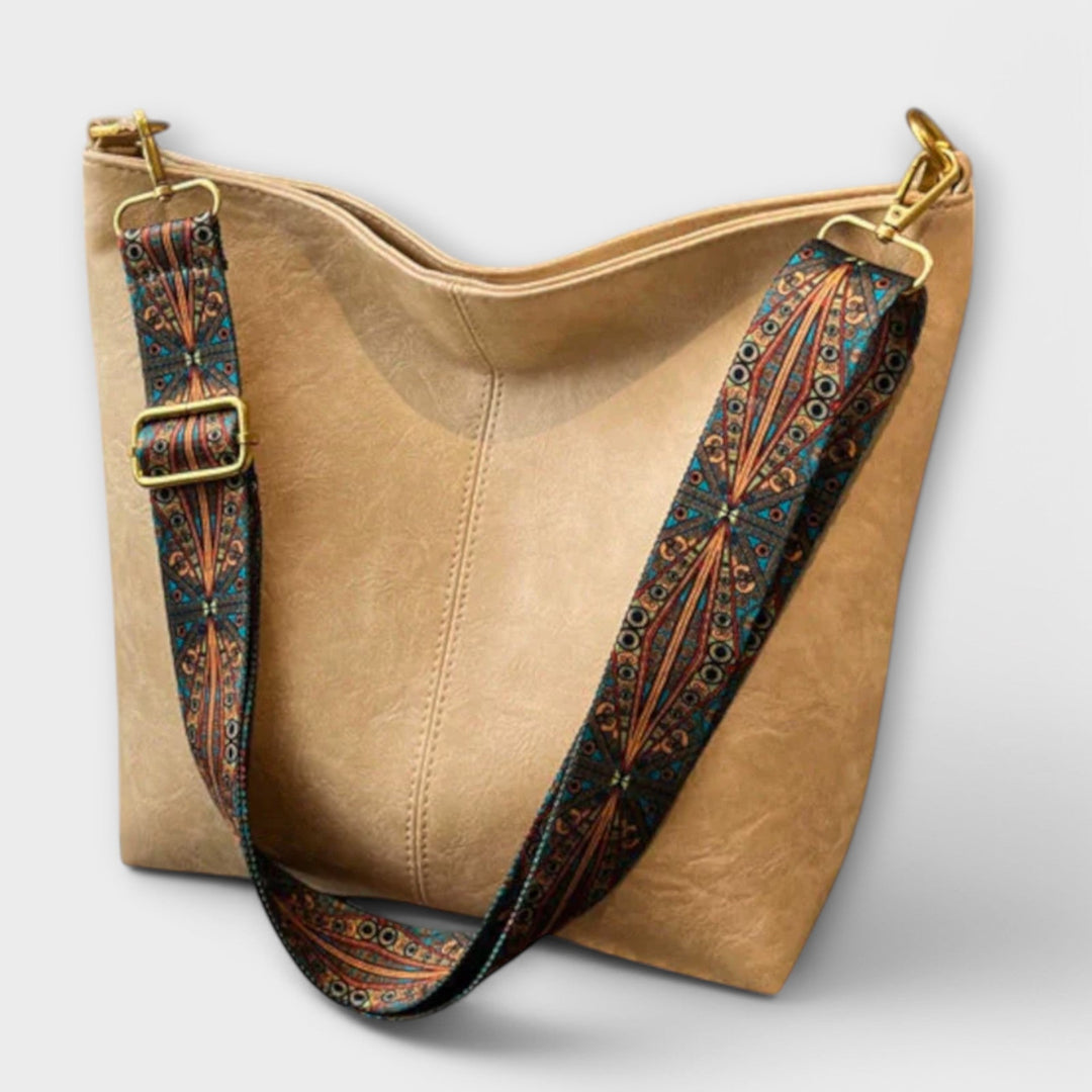 Fashionable black women's shoulder bag with braided strap on a model, versatile accessory