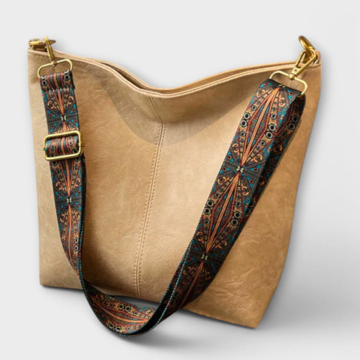 Fashionable black women's shoulder bag with braided strap on a model, versatile accessory