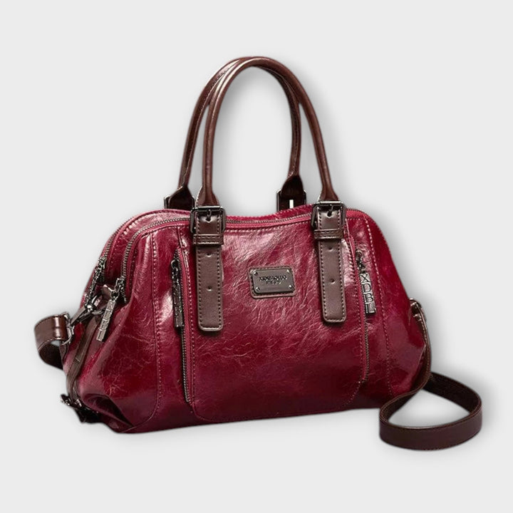 Close-up of a women's stylish black shoulder bag, showcasing textured material and refined details