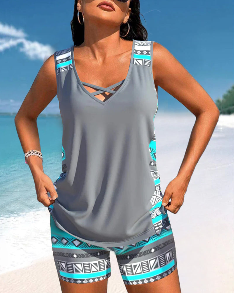 Vibrant printed women's tankini swimwear. Criss-cross top & matching bottoms for stylish beach days.