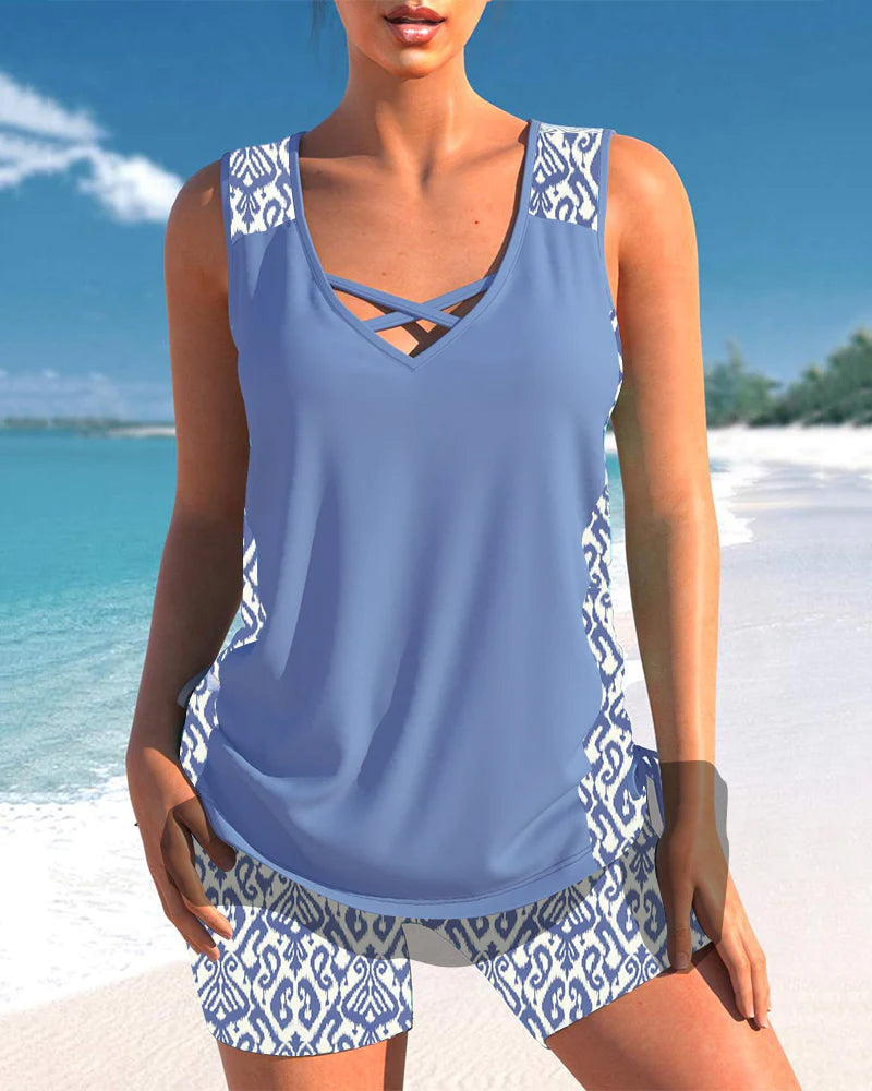 Stylish women's two-piece tankini with intricate criss-cross neckline. Essential resort & beachwear.