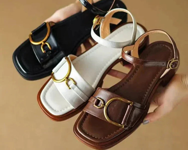 Elegant women's flat sandals featuring an adjustable buckle closure and fashionable square toe