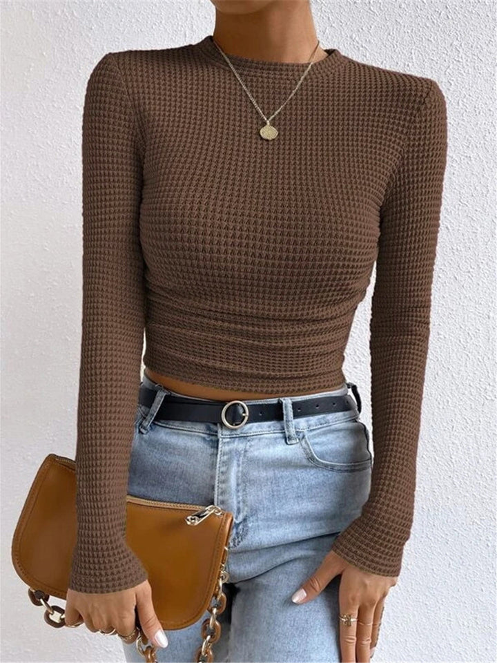 Casual long sleeve crop top in a neutral tone, an essential for women's summer style.