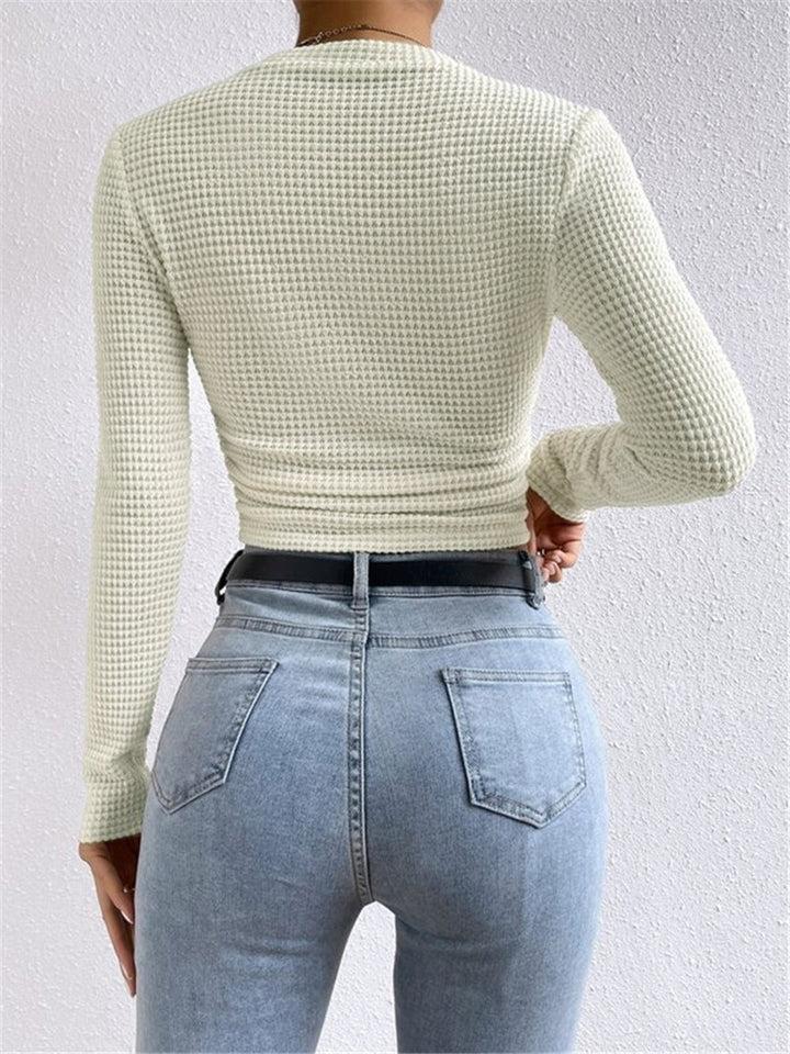 Trendy women's long sleeve crop top with a flattering fit, ideal for warm weather.