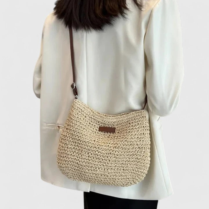 Beach-ready women's woven shoulder bag, embodying a relaxed summer fashion trend.