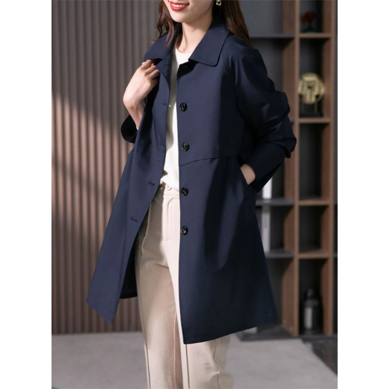 Elegant black women's tailored trench coat, mid-thigh length, offering a sophisticated and versatile outerwear option.