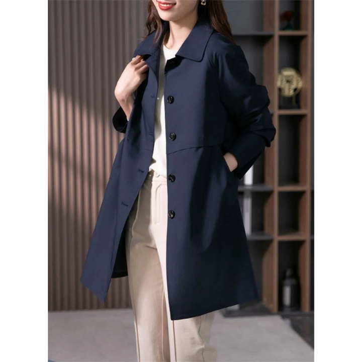 Elegant black women's tailored trench coat, mid-thigh length, offering a sophisticated and versatile outerwear option.