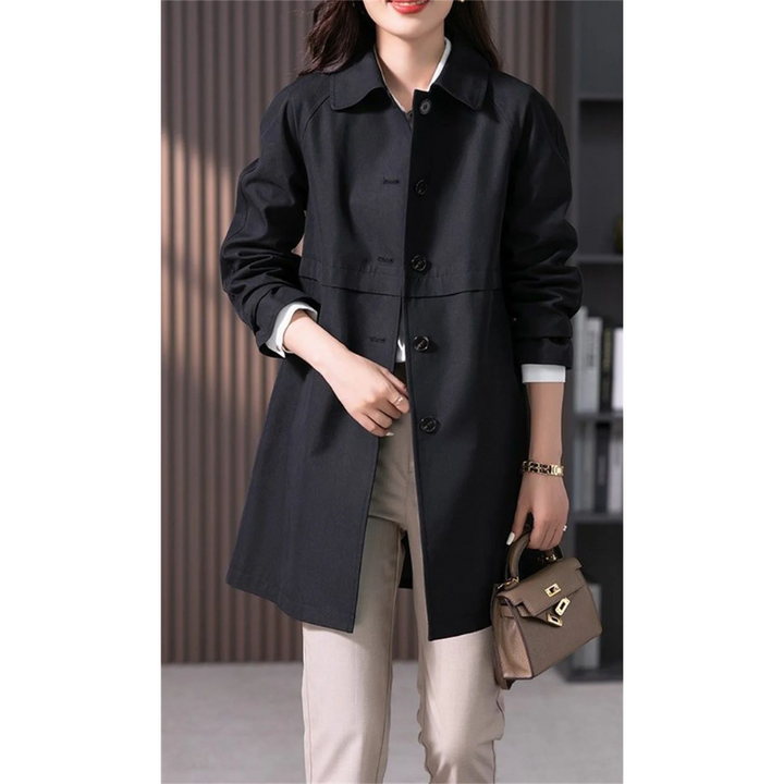 Stylish dark blue women's mid-thigh trench coat. Tailored fit for a classic, elegant autumn and spring outerwear.