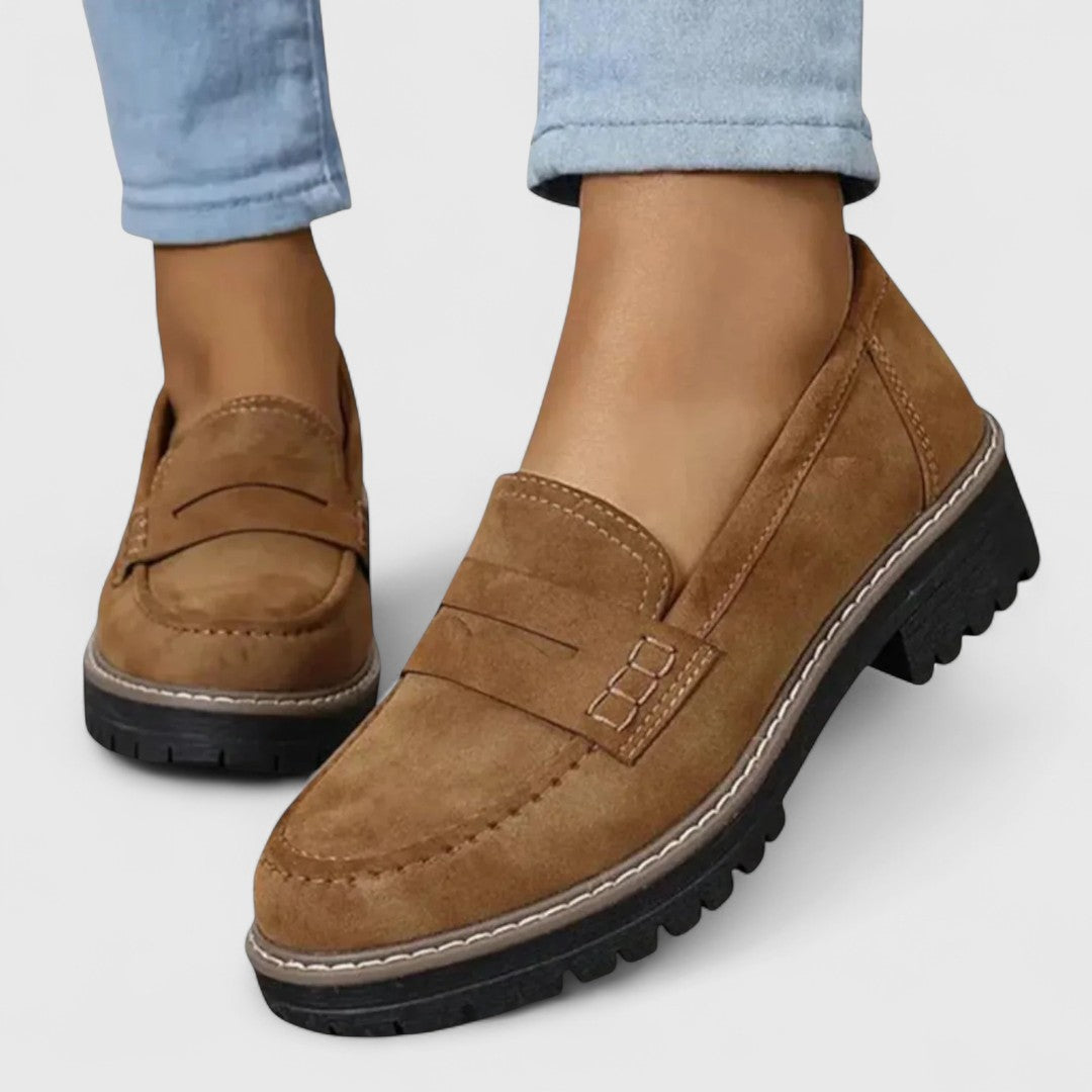 Pair of women's, slip-on orthopedic loafers in a neutral color, ideal for comfortable walking and casual wear.