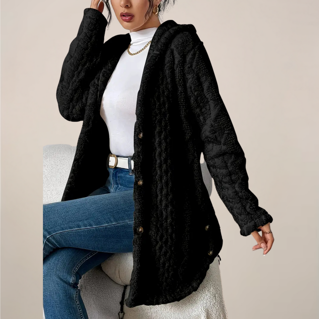 Close-up of the knit texture on a women's longline hooded cardigan, soft fabric.