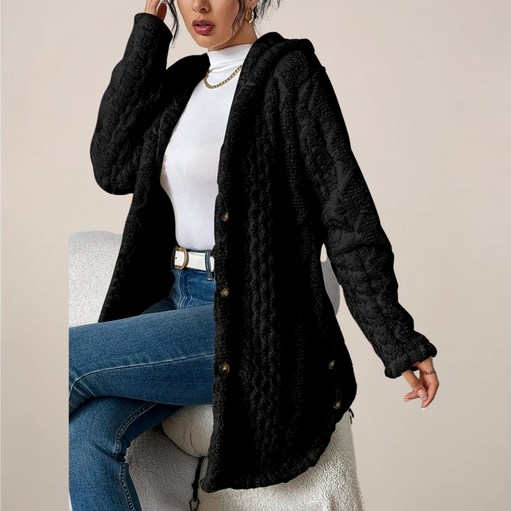 Close-up of the knit texture on a women's longline hooded cardigan, soft fabric.