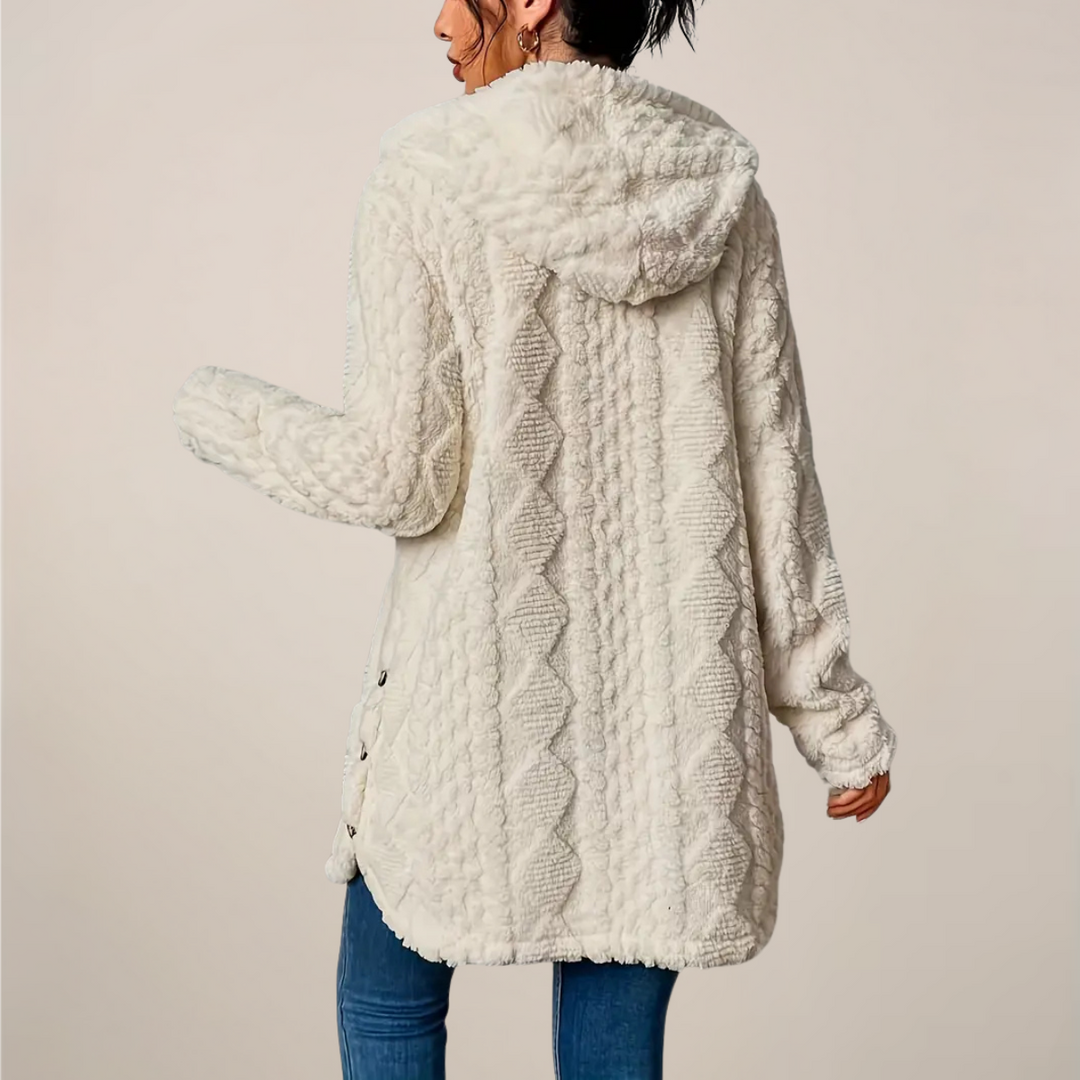 Folded women's textured hooded longline cardigan, showing the hood detail and soft material.
