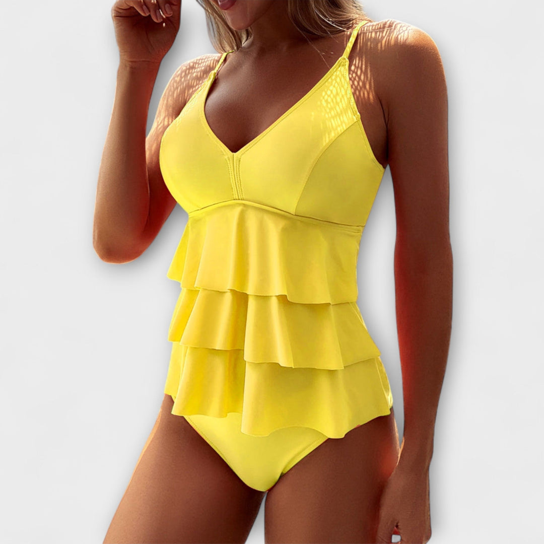 Fashionable women's ruffle tiered one-piece swimsuit in blue, perfect for summer vacation beachwear.