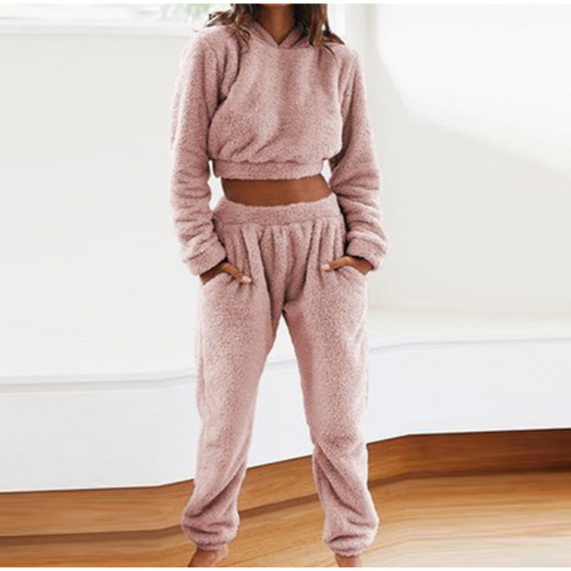 Modern women's two-piece loungewear: warm hooded sweatshirt & comfy drawstring pants for ultimate relaxation.