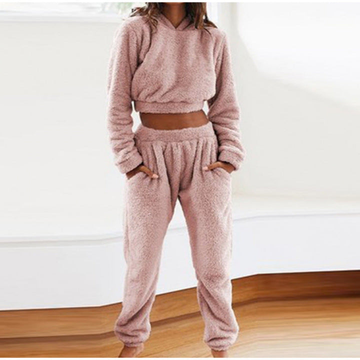 Modern women's two-piece loungewear: warm hooded sweatshirt & comfy drawstring pants for ultimate relaxation.