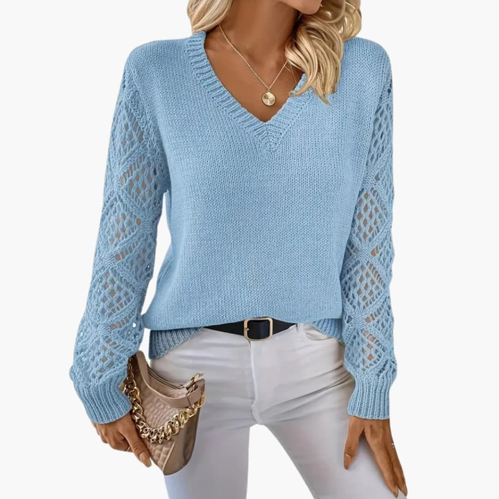 Cozy women's V-neck jumper with chic open sleeve detail, a comfortable and stylish choice for winter fashion.