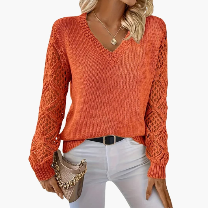 Fashionable women's V-neck top with eye-catching open sleeve detail, suitable for elegant or casual outfits.