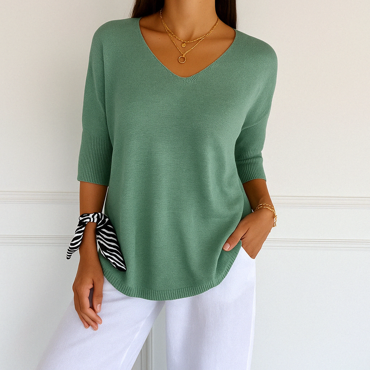 Close-up of the delicate knit texture on a women's V-neck short sleeve lightweight sweater.