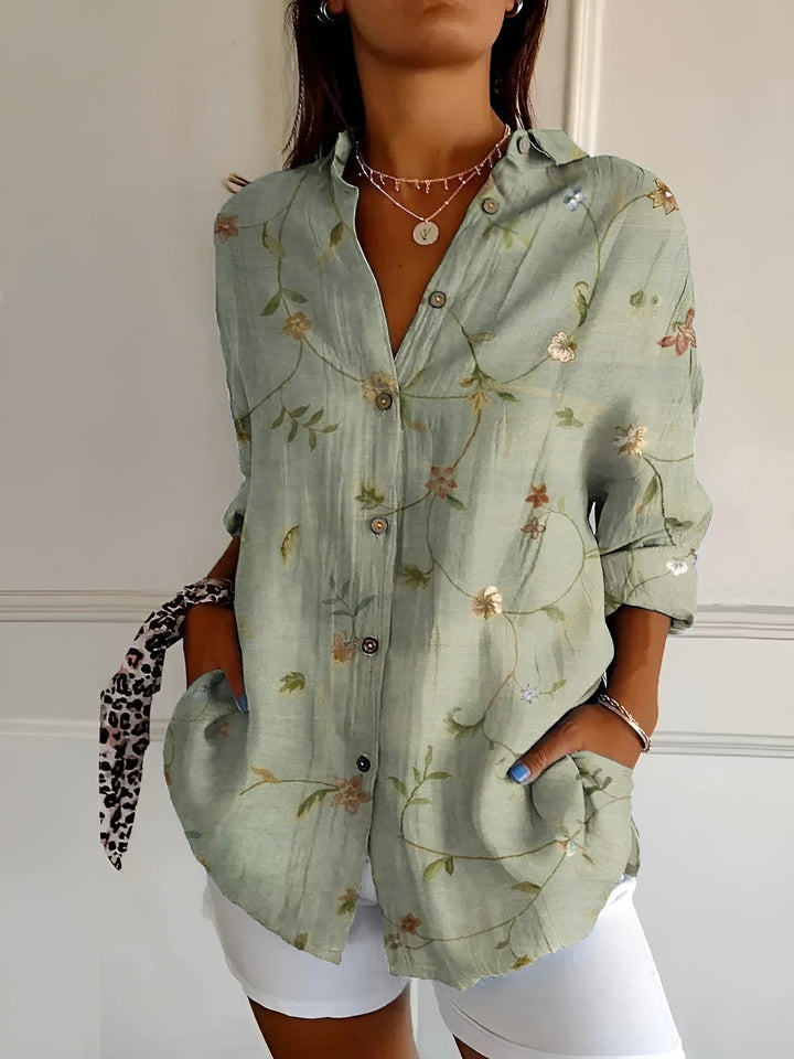 Comfortable loose-fit women's blouse with a vibrant floral print and button-front, ideal for summer fashion.