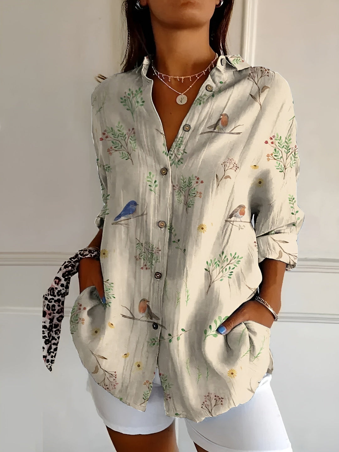 Close-up of a women's floral button-front blouse, showcasing the vibrant print and quality fabric for summer.