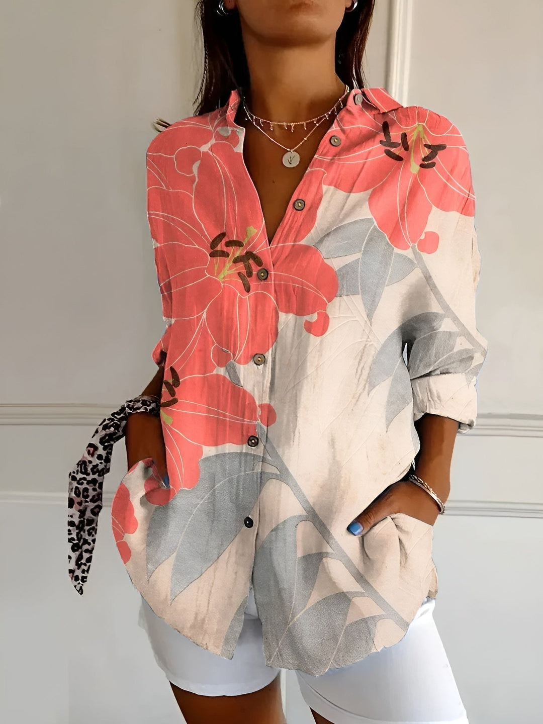 Vibrant floral print women's button-front blouse, offering comfortable loose fit for summer casual style.