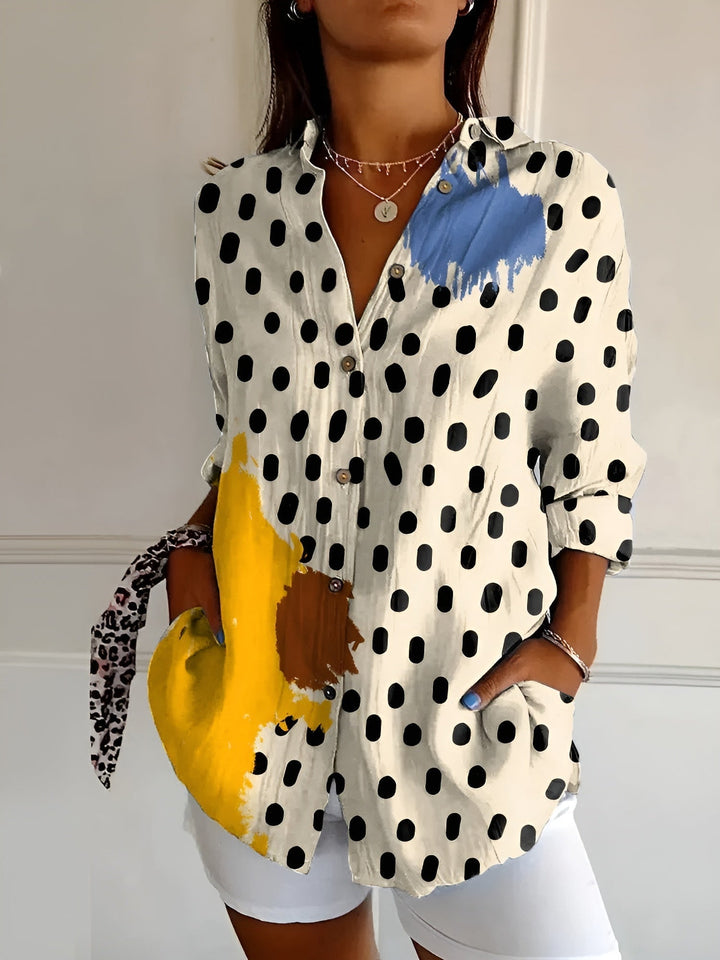 Women's vibrant floral button-front summer blouse. Comfortable, loose-fit, and stylish for casual wear.