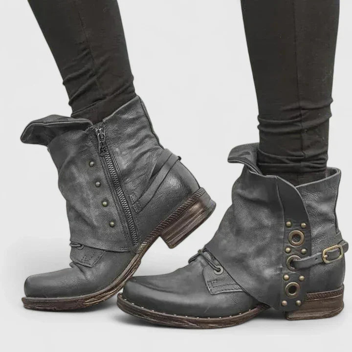 Close-up of a women's vintage buckle ankle boot, showcasing rich leather texture and unique strap details for spring