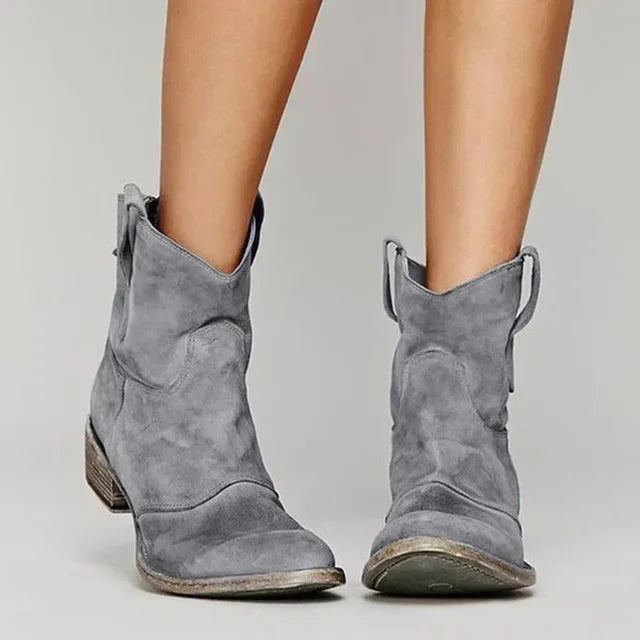 Pair of women's comfortable suede cowboy ankle boots with a fashionable block heel