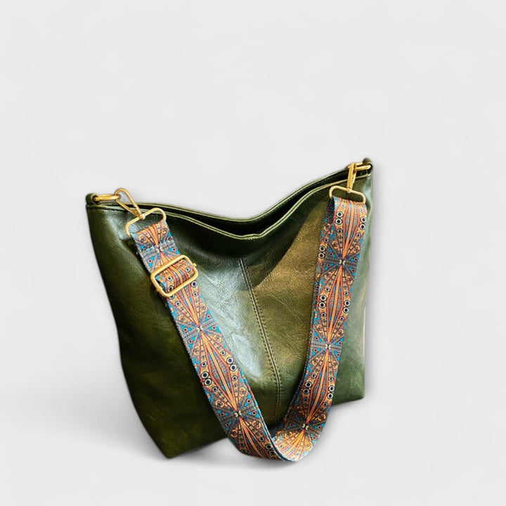 Close-up of embroidered strap on a women's vintage shoulder handbag, showcasing intricate design