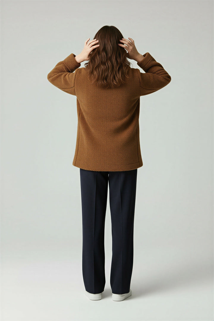 Close-up: Warm fabric of a women's oversized winter coat, highlighting its cozy texture. Stylish comfort outerwear.
