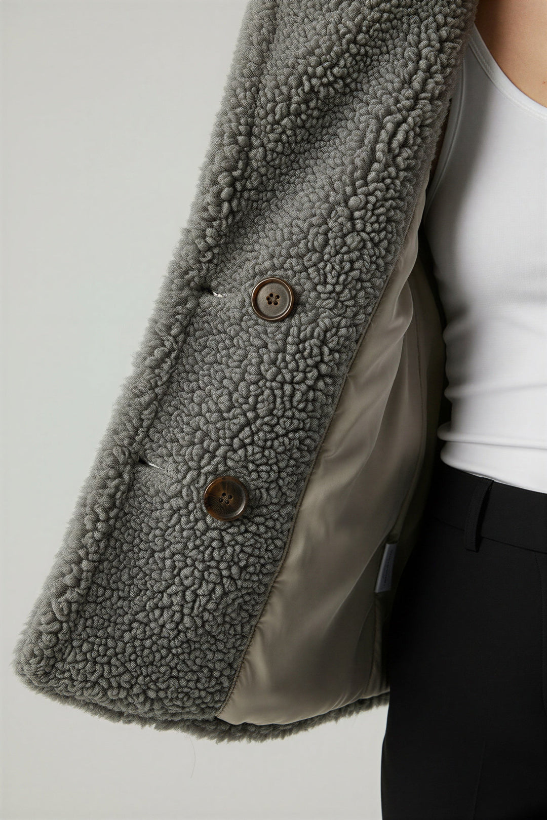 Back view: Cozy women's oversized winter jacket. Features comfortable, generous silhouette. Warm, stylish outerwear.
