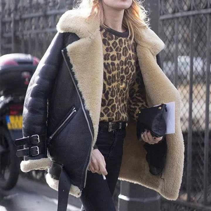 Stylish woman wearing a women's black faux leather biker jacket with plush lining, perfect for winter warmth and outerwear
