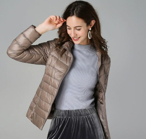 Elegant women's quilted jacket with a modern puffer design, offering warmth and style for winter outerwear.