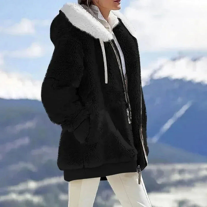 Detail of the robust zipper on a women's warm winter jacket, ideal for outdoor wear