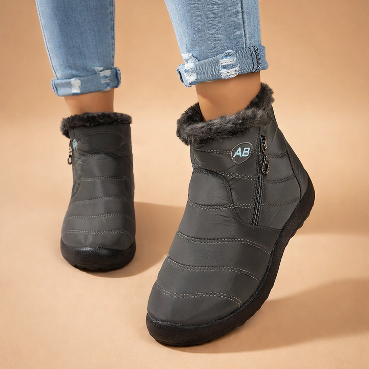 Durable women's winter ankle boots with a practical zip-up design, ensuring warmth and style for daily wear.