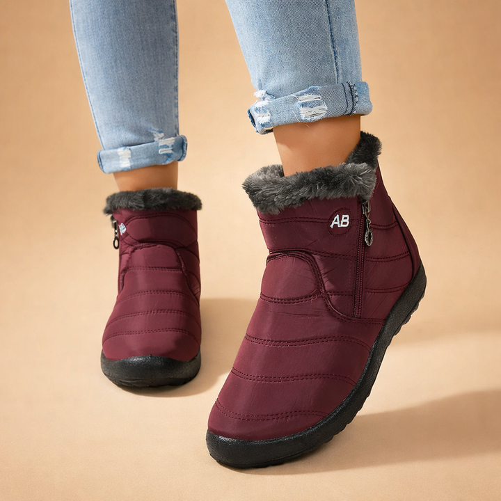 Front view of women's warm zip-up ankle winter boots, featuring a sleek design for everyday cold weather fashion.