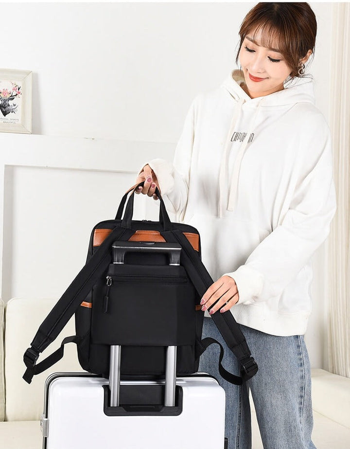 Woman wearing a water-resistant anti-theft travel backpack, showcasing its lightweight and stylish design.