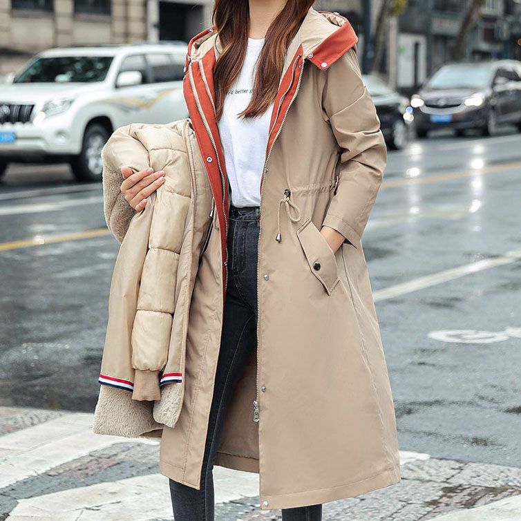 Women's waterproof hooded jacket for all-season weather protection.