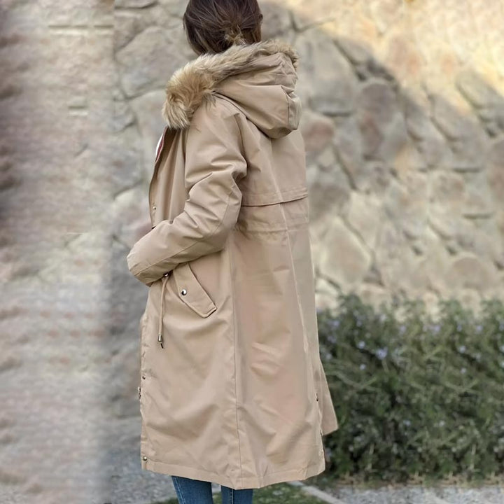 Women's waterproof hooded jacket with removable lining, offering all-season protection.