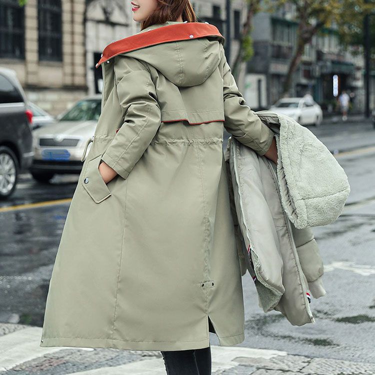 Durable women's waterproof jacket with hood, designed for all-season weather defense.