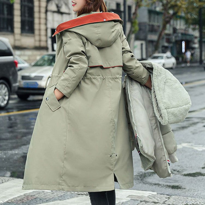 Durable women's waterproof jacket with hood, designed for all-season weather defense.