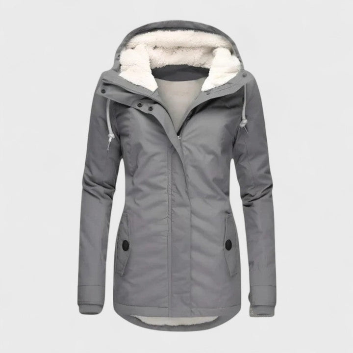 Women's waterproof winter parka with faux fur hood, providing warmth & protection for cold weather.