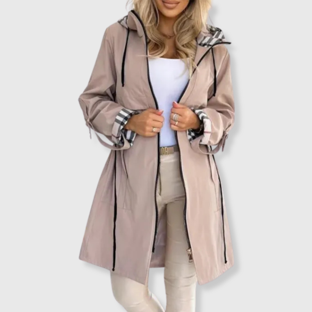 Close-up of women's zip-up rain coat, showcasing waterproof fabric and design