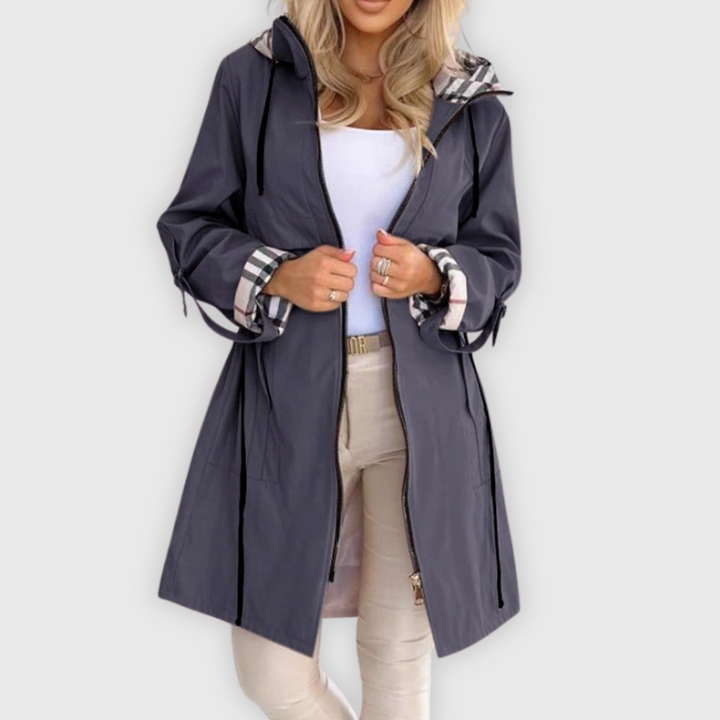 Detail of women's waterproof outerwear with zip closure and stand-up collar