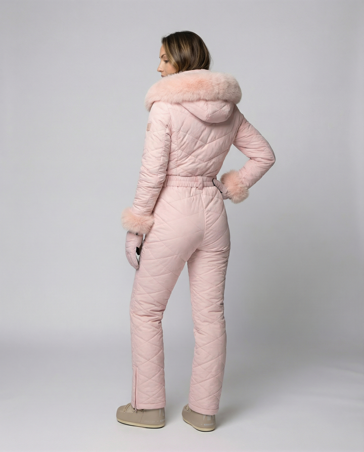 Durable women's weather-resistant snowboard overall suit with front zipper. Perfect winter jumpsuit for slopes.