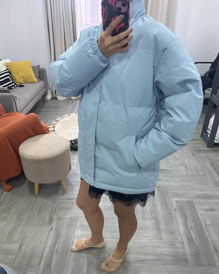 Elegant women's stand collar puffer jacket, offering warmth and style in cold weather.